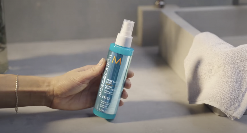 hand holding moroccanoil hair product