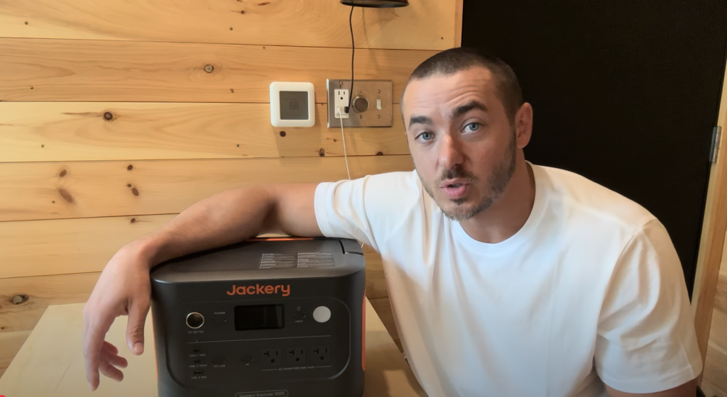 man showing jackery generator