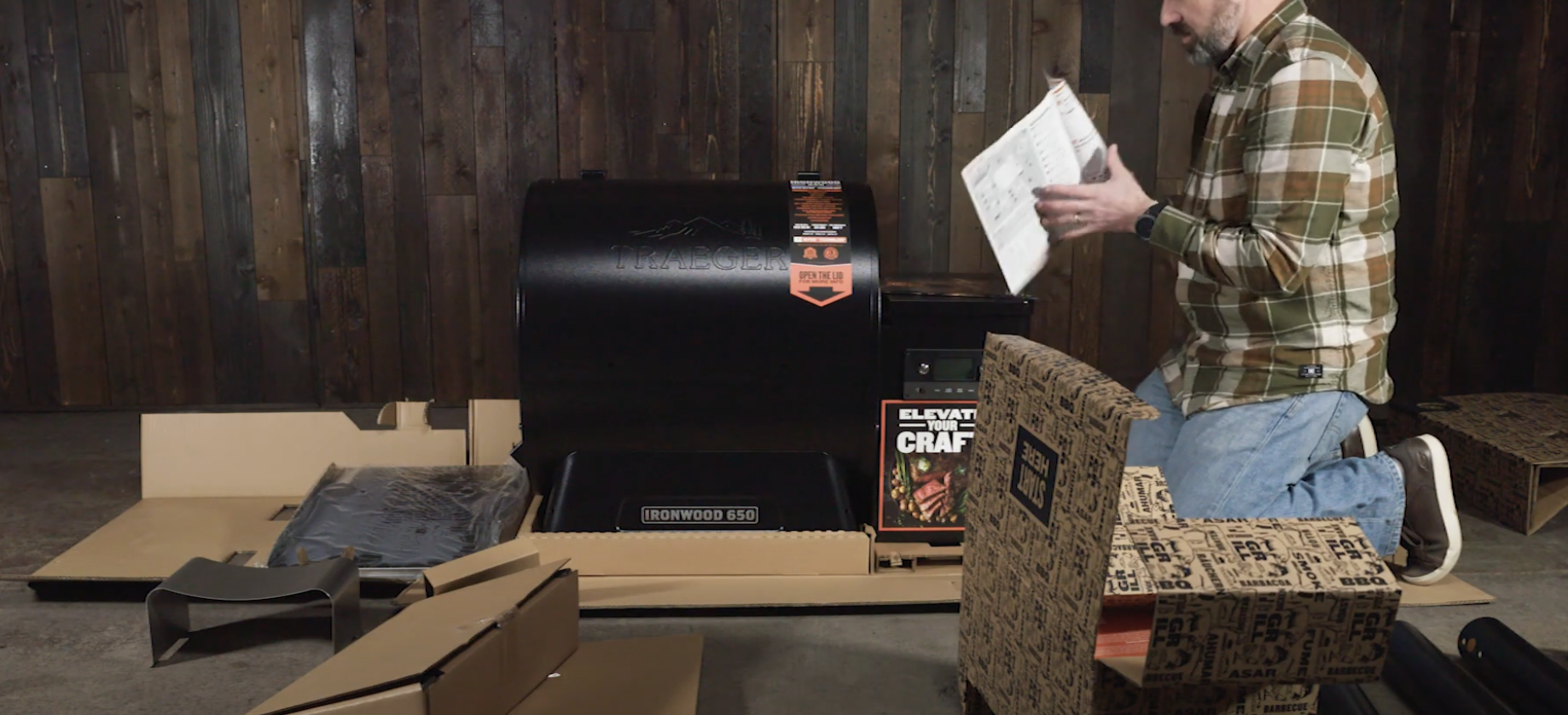 man assembling traeger grill