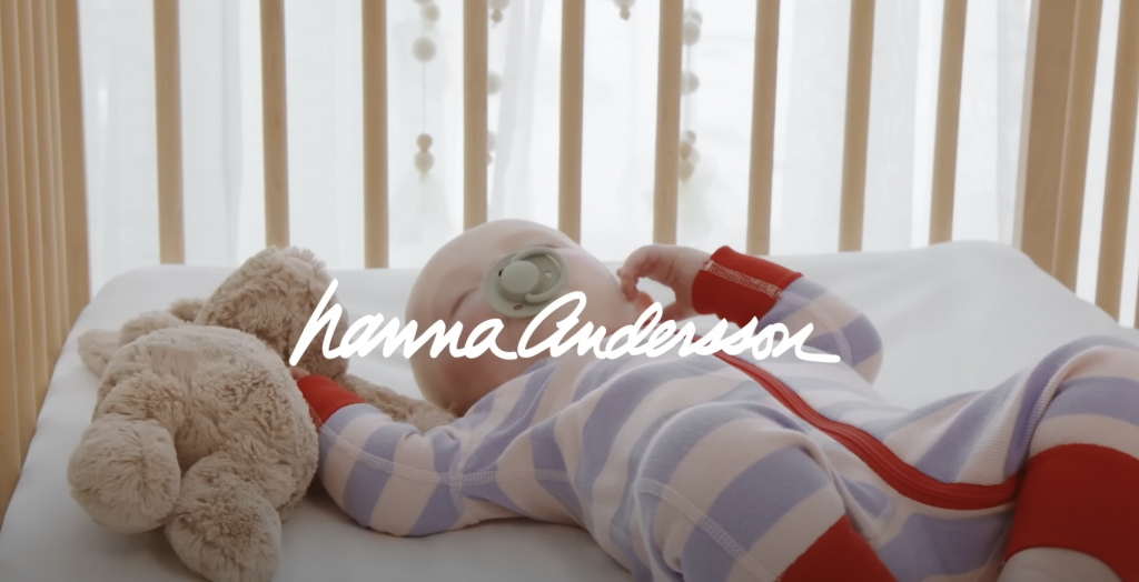 baby in pajamas lying in crib