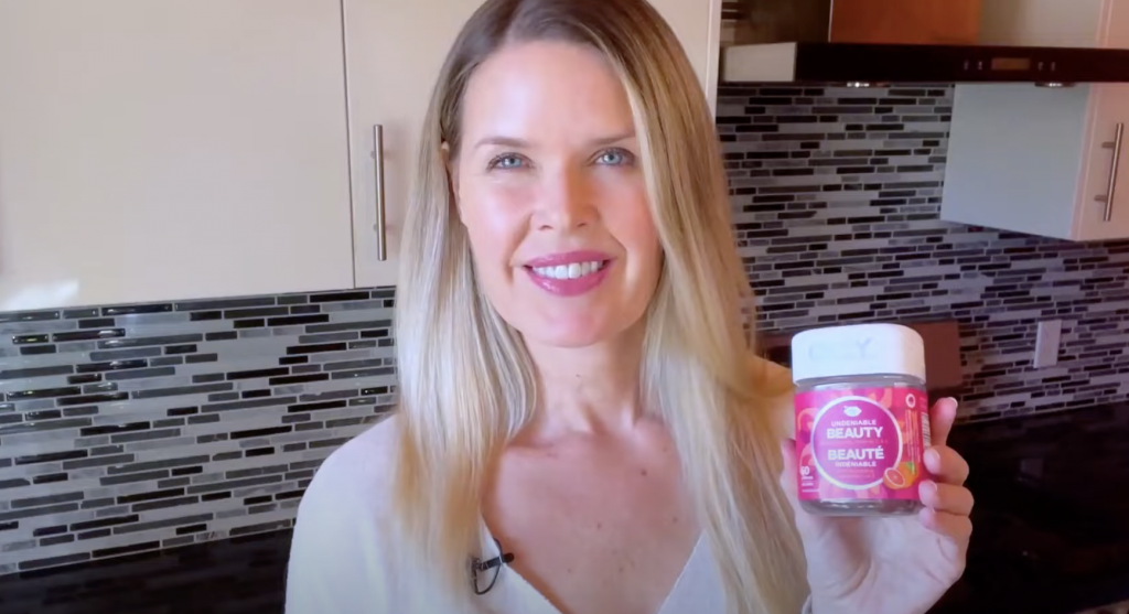 woman showing olly vitamin gummies