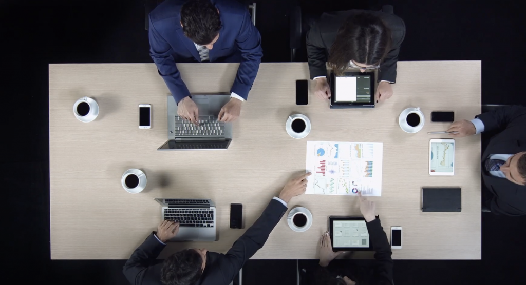 people meeting in office using laptops