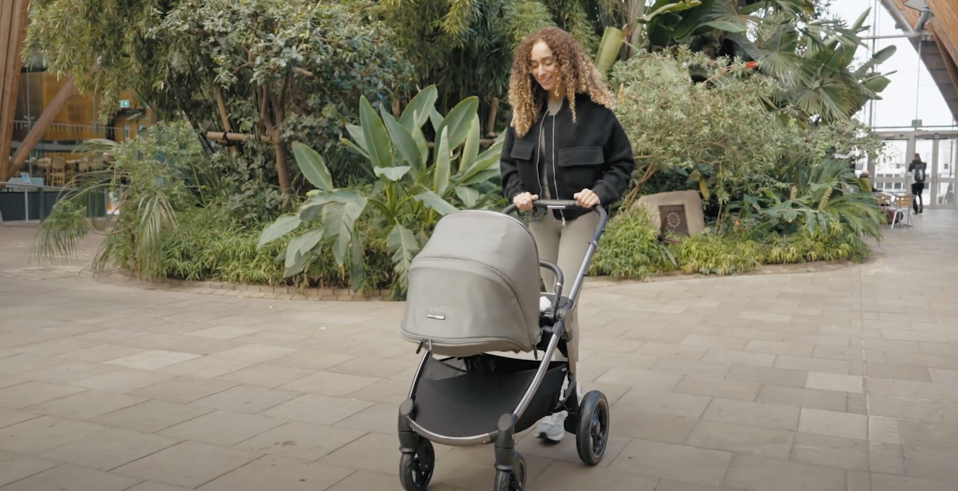 woman walking baby in car M...