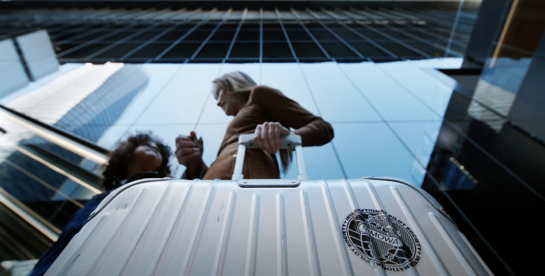 woman holding rimowa luggage