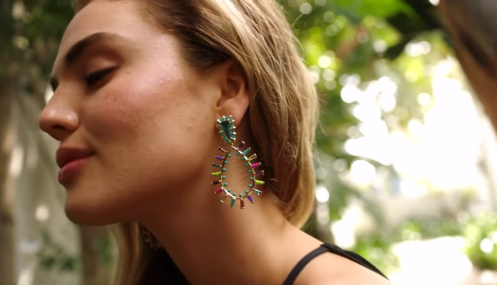 woman wearing Kendra Scott earrings