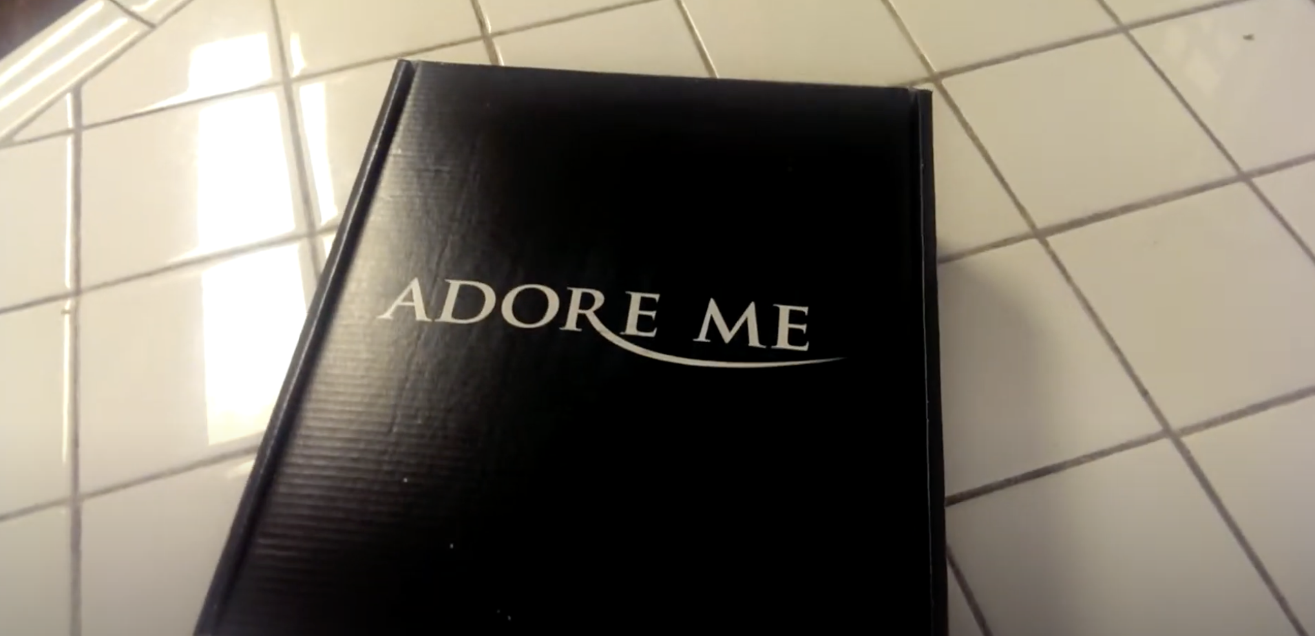 adore me box on the floor