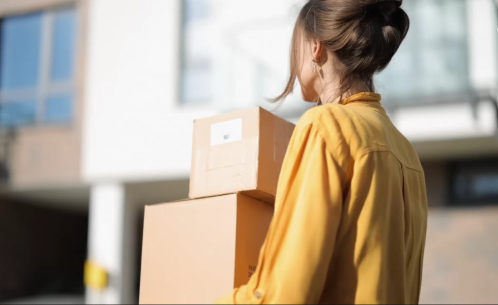 woman carrying some boxes