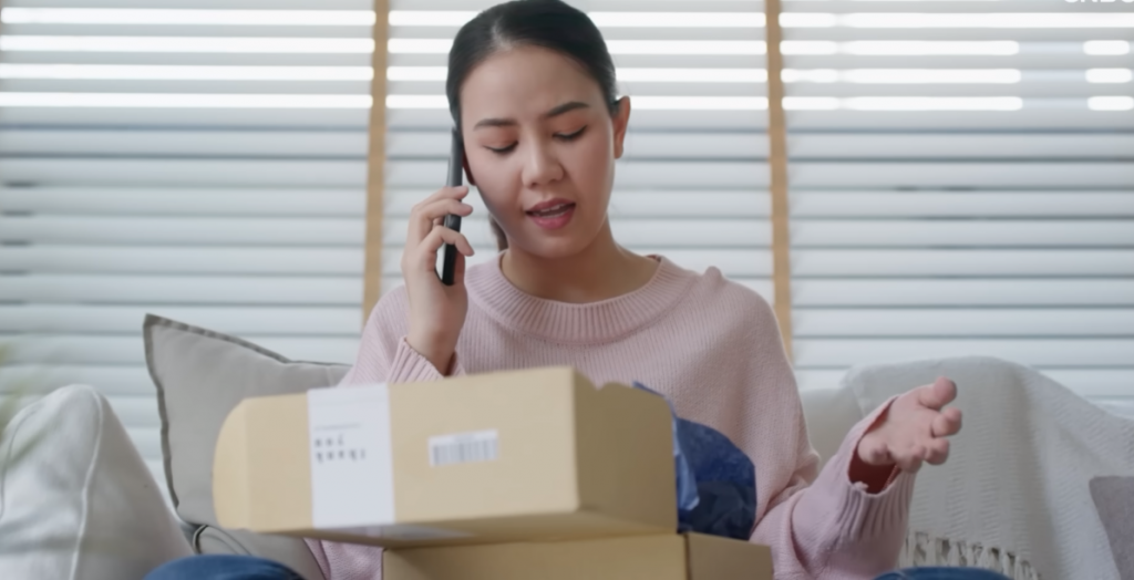 Woman talking on the phone to return package