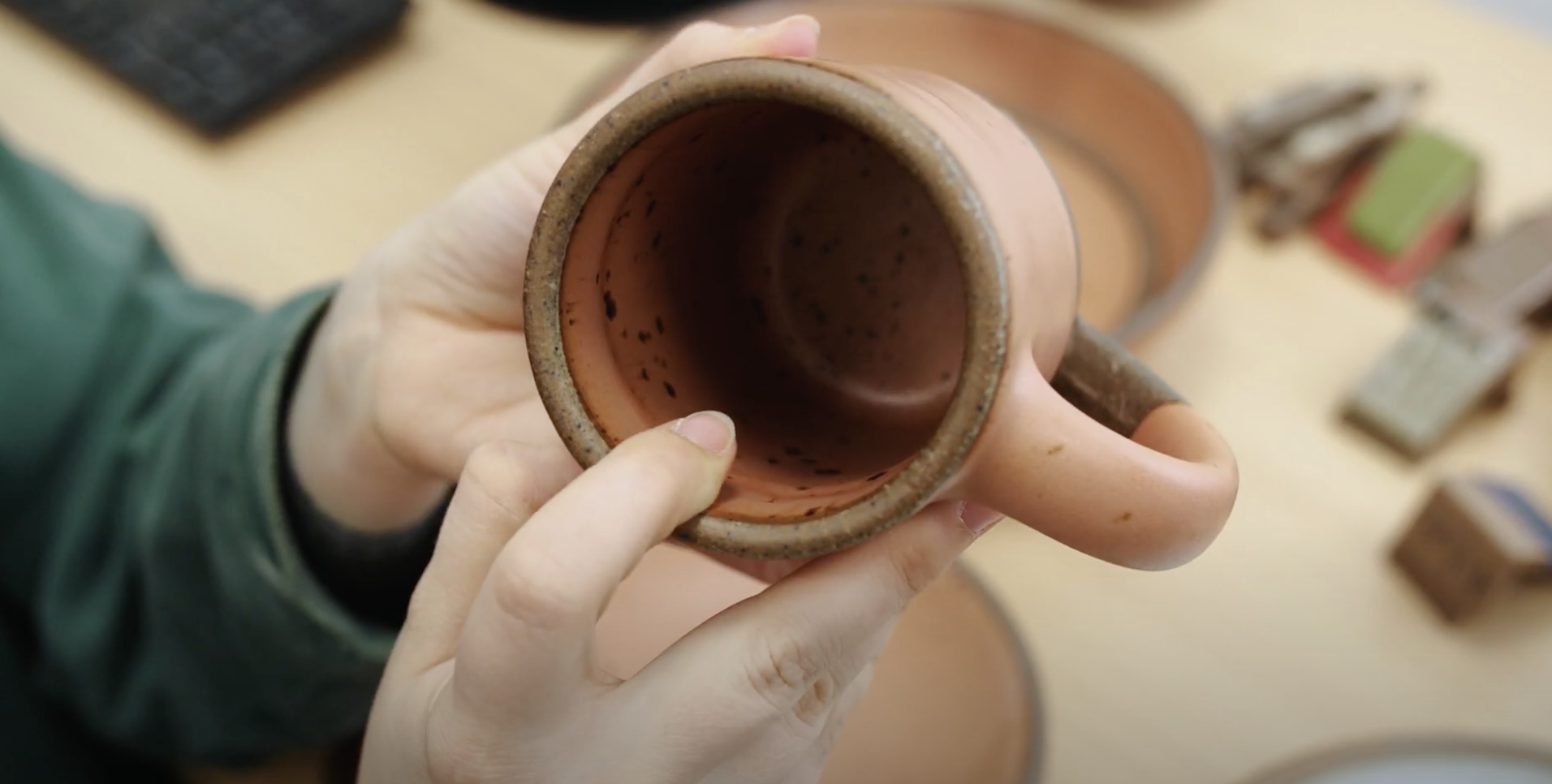 hand holding ceramic cup