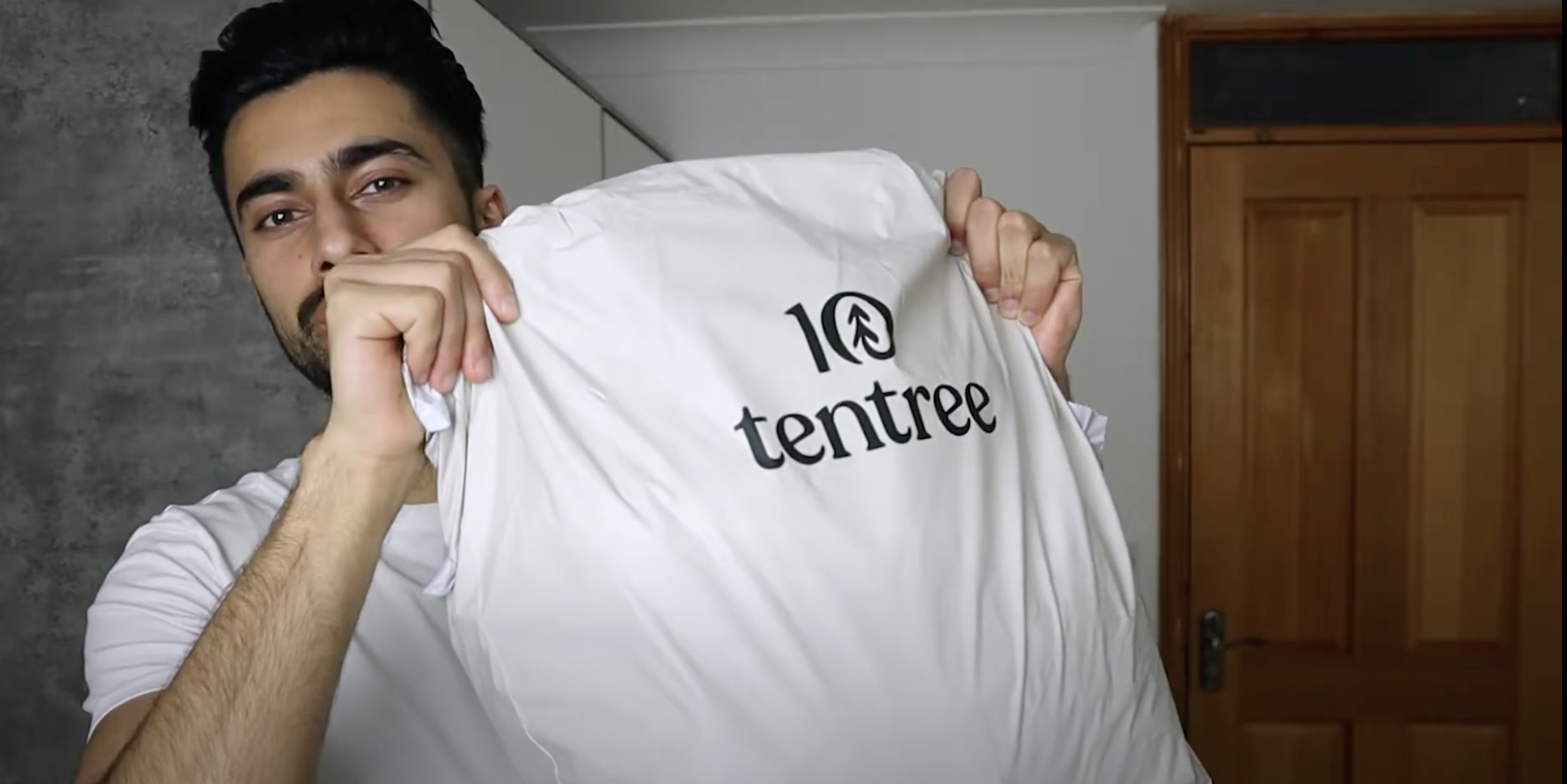 boy holding tentree shoppin...