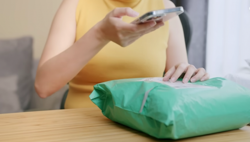 Woman taking a picture of her package guide