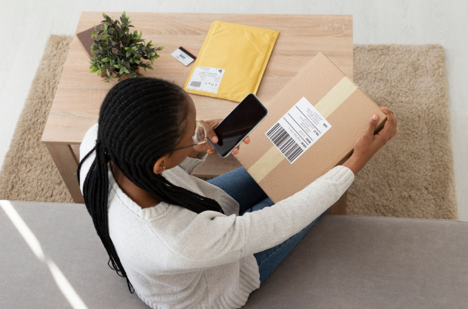 woman sitting on the floor scanning code with cell phone-cash register-shopping