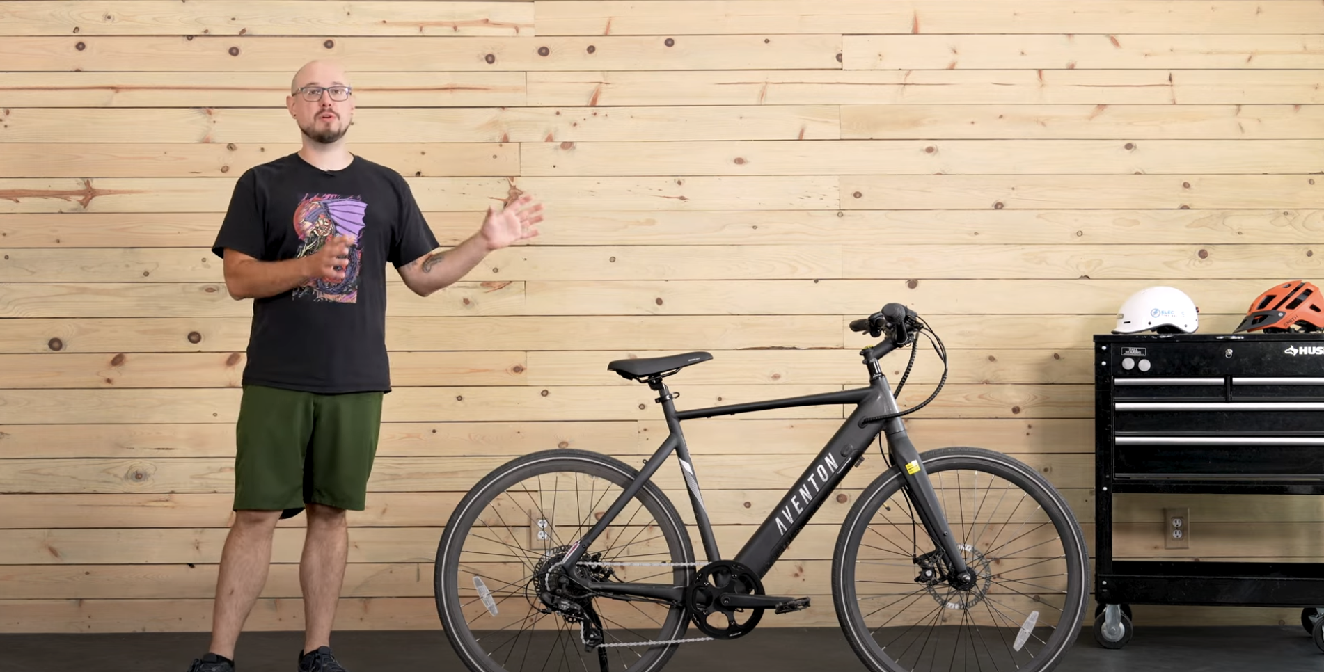 man showing black bicycle a...